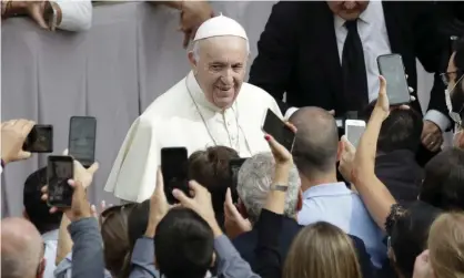  ?? Photograph: Andrew Medichini/AP ?? A team of people manage the pope’s various social media accounts.