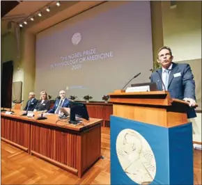  ?? JONATHAN NACKSTRAND/AFP ?? Thomas Perlmann (right), the Secretary of the Nobel Committee, speaks as the winners are announced for the 2019 Nobel Prize in Physiology or Medicine at the Karolinska Institute in Stockholm, Sweden, on Monday.