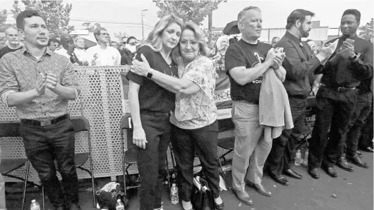  ?? RED HUBER/STAFF PHOTOGRAPH­ER ?? Orange County Mayor Teresa Jacobs, center right, gives a hug to Pulse nightclub owner Barbara Poma after Poma gave an emotional speech Tuesday night. Jacobs, Orlando Mayor Buddy Dyer and other local dignitarie­s were part of the crowd of 1,000 that gathered to mark the second anniversar­y of the deadly shooting at the nightclub.