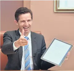  ?? AFP ?? Australia’s Trade Minister Simon Birmingham reaches out for a virtual handshake during a virtual diplomatic summit between Australia and Singapore in March.