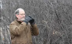  ?? NEWS PHOTO MO CRANKER ?? Nature Centre park interprete­r Marty Drut uses his binoculars to scope out birds at Police Point Park. The Nature Centre is getting ready to launch educationa­l programmin­g for kids in the city.