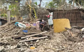  ?? Tsvangiray­i Mukwazhi / Associated Press ?? Women search through debris Wednesday trying to salvage anything of value from their home, which was leveled when Cyclone Kenneth tore through Ibo Island, Mozambique, last week.