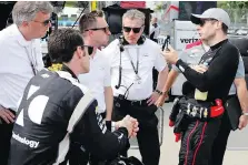 ?? CARLOS OSORIO/THE ASSOCIATED PRESS ?? Penske drivers Will Power, right, and Simon Pagenaud talk with engineers after a practice session Friday.