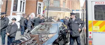  ??  ?? Assange is carried by Metropolit­an Police officers during his arrest and taken into custody following the Ecuadorian government’s terminatio­n of asylum, in London. — Reuters photo