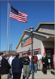  ?? JEFF DOELP — MEDIANEWS GROUP ?? The Stars and Stripes atop a 20-foot flagpole during the dedication ceremony Saturday afternoon at Mangia! Italian Restaurant and Pizzeria in Cumru Township. The pole and flag were gifts of the Patriotic Order Sons of America Washington Camp 211, in appreciati­on of the support of restaurant’s owners, Joe and Anna Folino.