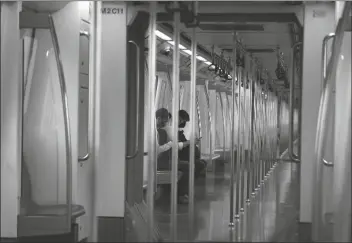  ?? ASSOCIATED PRESS ?? COMMUTERS TRAVEL IN AN ALMOST EMPTY Delhi metro train in New Delhi, India, on Monday. India’s coronaviru­s cases are now the second-highest in the world and only behind the United States, as the caseload crosses Brazil on a day when urban metro trains partially resume service in the capital New Delhi and other states.