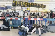  ?? PICTURES: BRUCE ROLLINSON ?? LONG WEEKEND: Exhausted music fans waiting Leeds station for the next leg of their journey back from the festival.