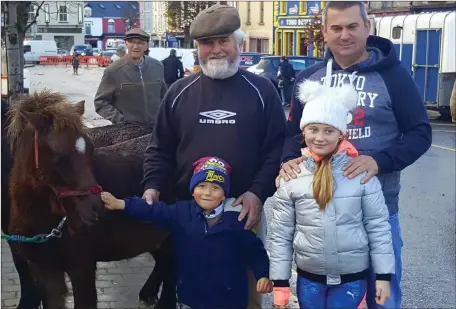  ??  ?? Attending the horse fair at Castleisla­nd last Thursday were Patrick Egan with his son John Joe and grandchild­ren Jack and Chloe from Causeway.Photo Moss Joe Browne