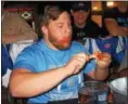  ?? JOHN KAMPF — THE NEWS‑HERALD ?? South’s Sean Scherl, above, and teammate Jitesh Patel won The News‑Herald Senior Bowl wing‑ eating contest on May 22 .