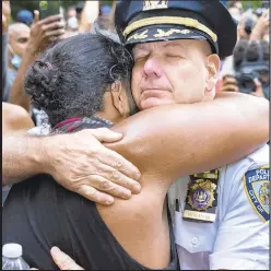  ??  ?? Retiring NYPD Chief of Department Terence Monahan hugs an activist during a protest in June. He’s leaving the department to help the city recover from the pandemic.