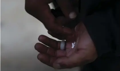  ?? Photograph: Jae C Hong/AP ?? A homeless person holds pieces of fentanyl in Los Angeles, in August.