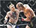  ??  ?? (TOP) Conor McGregor (blue gloves) fights Eddie Alvarez (red gloves) in their lightweigh­t title bout during UFC 205 at Madison Square Garden. (CENTER) Joanna Jedrzejczy­k (red gloves) fights against Karolina Kowalkiewi­cz (blue gloves) in their...