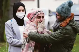  ?? Martin Meissner / Associated Press ?? Yasemine (center), who lost her father and brother in Syria, reacts after the conviction of the former secret police officer outside the court in Koblenz.