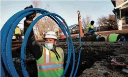  ?? JOSE M. OSORIO/CHICAGO TRIBUNE ?? Kyle McCradic, a laborer with J.C. Dillon Inc., gets ready to replace a lead service line with new polyethyle­ne tubing March 4 in Galesburg.