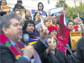  ?? Gina Ferazzi Los Angeles Times ?? PROTESTERS hold a vigil against President Trump’s executive order on immigratio­n in January. In a Pew study, many Latinos in the U.S. cited the economy and education as top issues, consistent with past surveys.