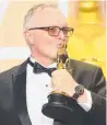  ??  ?? Australian Lee Smith with the Best Film Editing award for Dunkirk.