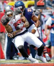  ?? BRIAN BLANCO / GETTY IMAGES ?? Mike Evans secures one of his seven receptions in the Buccaneers’ 29-7 win over the Bears. He had a 13-yard TD catch in the first quarter.