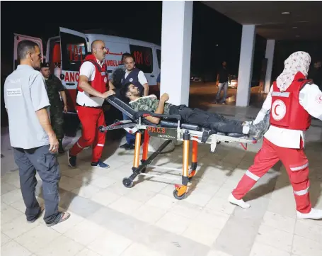  ?? AFP ?? Injured Palestinia­ns are transporte­d to the hospital on Thursday in Jericho, West Bank. They were injured during an Israeli raid in the Jaber refugee camp.