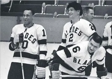  ?? Bruce Bennett Getty Images ?? WILLIE O’REE (10) and Los Angeles Blades teammates talk before a game at the Sports Arena during the 1963-64 season. “He’s changed who knows how many kids’ lives,” a current minor leaguer says of O’Ree.