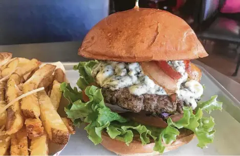  ?? Alison Cook / Staff ?? Blue cheese and bacon burger at Alfred’s Burger House