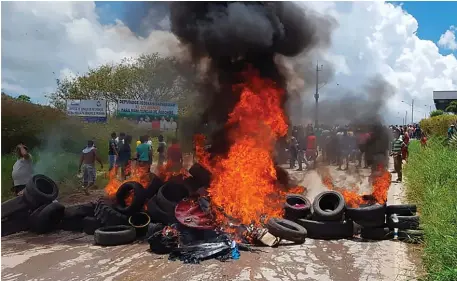  ??  ?? Residents of the Brazilian border town of Pacaraima burn tyres and belongings of Venezuelan immigrants after attacking their two main makeshift camps, leading them to cross the border back into their home country. Photo: Isac Dantes/AFP/Getty