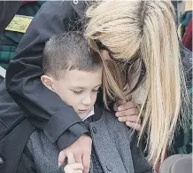  ?? WAYNE CUDDINGTON/ OTTAWA CITIZEN ?? Nicole Cirillo comforts Marcus Cirillo, son of Nathan Cirillo, during the memorial service Thursday.