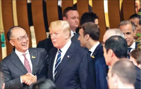 ?? STEPHEN CROWLEY/THE NEW YORK TIMES ?? United States President Donald Trump greets World Bank President Jim Yong Kim during the G20 summit in Hamburg, Germany, on July 7.