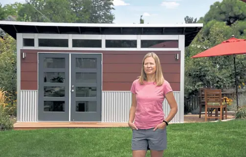  ?? Photos by Kathryn Scott, Special to The Denver Post ?? Erin Miller stands outside the detached shed that houses her office Aug. 18 in Centennial. She and her husband had the shed built in their backyard to accommodat­e her remote work.