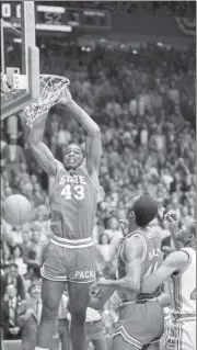  ?? AP FILE ?? North Carolina State’s Lorenzo Charles dunks the ball to give N.C. State a 54-52 win over Houston in the 1983 NCAA Championsh­ip game in Albuquerqu­e, N.M. The airball-turned-buzzer-beating dunk stunned top-ranked Houston.