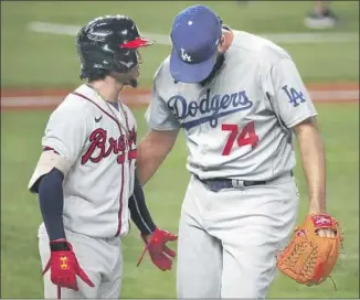  ?? ATLANTA BRAVES Robert Gauthier Los Angeles Times ?? second baseman Ozzie Albies and Dodgers reliever Kenley Jansen cross paths after Jansen retired Albies. Jansen got out the side in order, but two of the outs were hard hit.