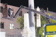  ?? GERALD HERBERT/ASSOCIATED PRESS ?? Workers dismantle the Liberty Place monument, which commemorat­es whites who tried to topple a biracial post-Civil War government, on Monday in New Orleans.