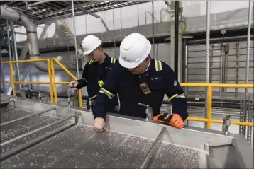  ?? ?? Dustin Olson, chief executive of Purecycle Technologi­es, looks at recycled polypropyl­ene pellets at the company’s plant in Ironton, Ohio, on March 13. The plant is part of a new wave of “advanced” or “chemical” plastic recycling plants that the plastics industry has hailed as a solution to an exploding global waste problem.