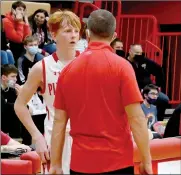 ?? PILOT PHOTO/MAGGIE NIXON ?? Coach Bales talks with Nolan Bales during a recent home game. The duo tries their best to keep it “coach” on the floor and “dad” at home.