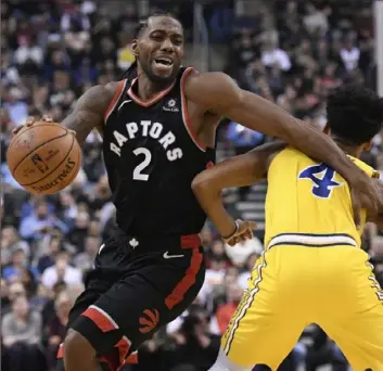  ?? Associated Press ?? CUTTING THE CORNER Toronto’s Kawhi Leonard, left, finds a little leverage to get around Golden State’s Quinn Cook in the first half Thursday night in Toronto.