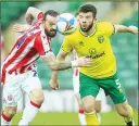  ??  ?? TUSSLE: Stoke’s Steven Fletcher, left, and Norwich’s Grant Hanley