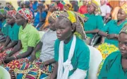  ?? AFP ?? Some of the recently released girls from Chibok wait in Abuja on Monday. The teenage girls, who were among more than 200 kidnapped by Boko Haram, were freed on Saturday after a prisoner swap agreed with the Islamist group.