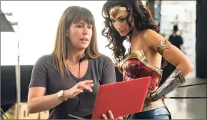  ?? Clay Enos / AP ?? Director Patty Jenkins, left, with actress Gal Gadot on the set of "Wonder Woman 1984."