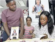  ??  ?? Veronica Campbell-Brown (right) autographs a copy of her book ‘Inside Out’ for Sowande Brown (left) and Lillian West during a book signing at Fontana Pharmacy, Barbican Square, yesterday.