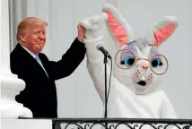  ?? AP ?? US President Donald Trump and the Easter Bunny wave to the crowd from the Truman Balcony during the annual White House Easter Egg Roll yesterday.