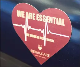  ?? Tyler Sizemore / Hearst Connecticu­t Media ?? A magnet is displayed on a car parked at RegalCare nursing and rehabilita­tion center in Greenwich on Tuesday.
