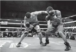  ?? Associated Press ?? Oscar Escandon, left, is knocked down by Gary Russell Jr. in the fourth round of the WBC Featherwei­ght Championsh­ip fight Saturday in Oxon Hill, Md.