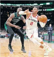  ?? USA TODAY SPORTS ?? The Rockets’ Russell Westbrook drives past the Celtics’ Jaylen Brown.