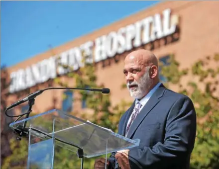  ?? DIGITAL FIRST MEDIA FILE PHOTO ?? Jeff Hunt,CEO of Brandywine Hospital, center speaks at the Oct. 2 launch of the hospital’s purchase by Reading Health System — now called Tower Health. The sale also included Jennersvil­le, Phoenixvil­le, Brandywine and Pottstown hospitals.