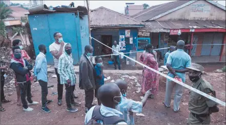  ?? Photo: Nampa/AFP ?? Tense… People wait in a line to vote at a polling station in Kampala.