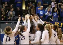  ?? DREW ELLIS — MEDIANEWS GROUP ?? Birmingham Marian raises the Division 1volleybal­l state championsh­ip trophy following its 25-18, 25-22, 25-18, 25-19win over Ann Arbor Skyline on Saturday from Kellogg Arena in Battle Creek.