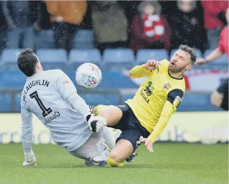  ??  ?? Jon McLaughlin makes an important save to deny Matty Taylor.