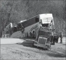  ?? Arkansas Democrat-Gazette/STATON BREIDENTHA­L ?? FATAL CRASH: Tow truck operator work Monday to recover a bus involved in a fatal crash on Interstate 30 at mile marker 111 in Saline County.
