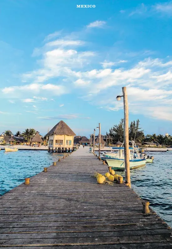  ?? Markviktor Getty Images/iStockphot­o ?? ISLA HOLBOX, off Mexico’s Yucatán Peninsula, is a relaxed, affordable beach destinatio­n surrounded by turquoise waters. It’s a short boat ride to the whale sharks.