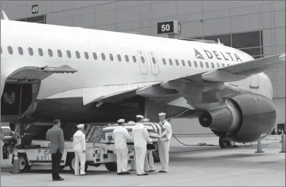  ?? The Associated Press ?? CLOSURE: Navy sailors carry the casket of Lt. Cmdr. Frederick Crosby after its arrival to the airport Friday in San Diego. After spending more than half a century on getting her father’s remains recovered from Vietnam after his Navy plane was shot down...