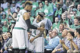  ?? CURTIS COMPTON / CCOMPTON@AJC.COM ?? Jared Sullinger restrains Isaiah Thomas after a scuffle with Dennis Schroder in Friday’s playoff game.